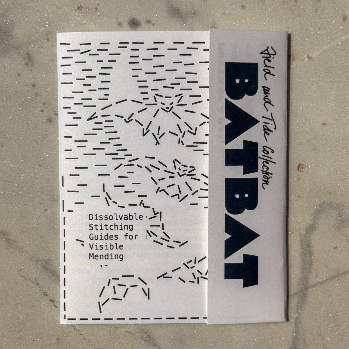 Batbat dissolvable stitching guide on a textured surface