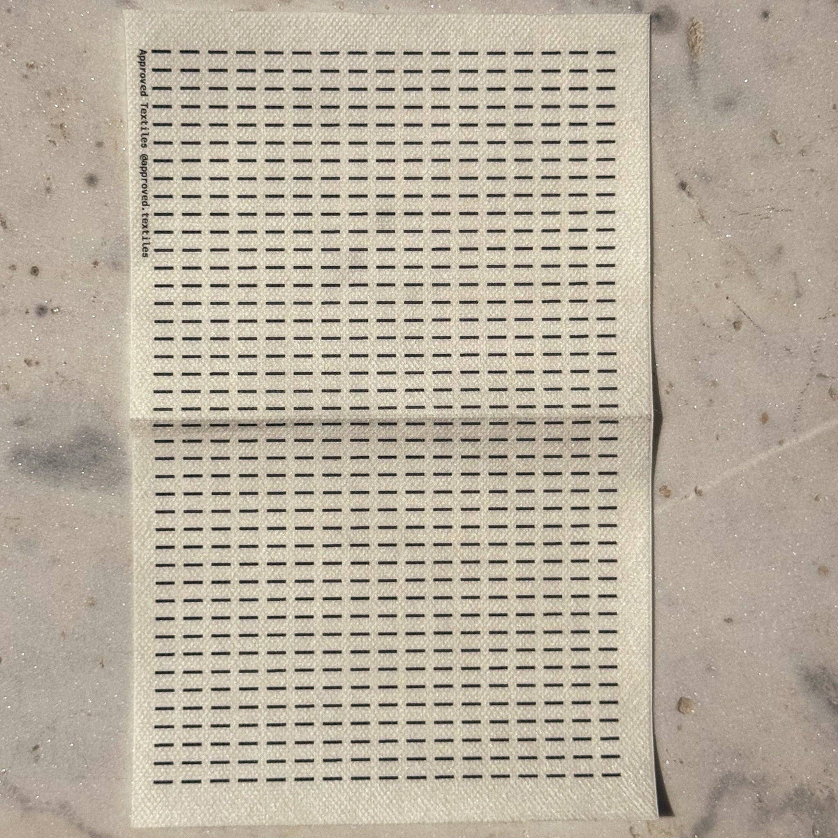 Visible mending guide sticker featuring many rows of horizontal lines. 