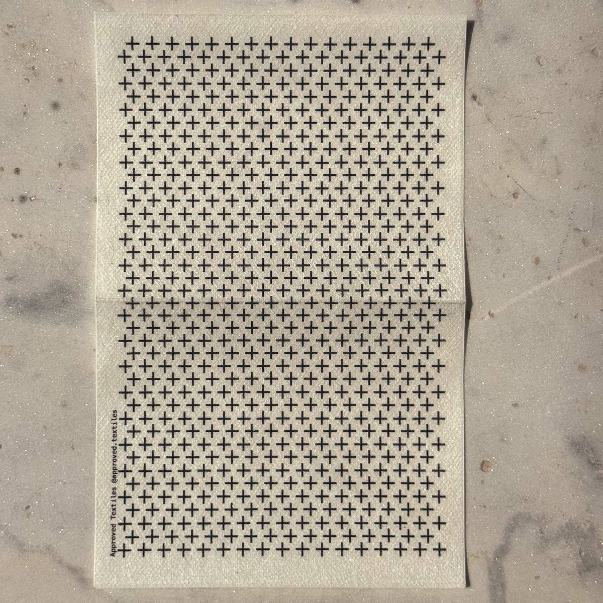 Visible mending guide sticker featuring many rows of plus sign shapes. 