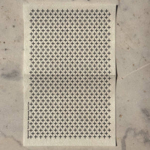 Visible mending guide sticker featuring many rows of plus sign shapes. 