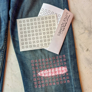 Embroidery design on jeans with a pattern nearby. 