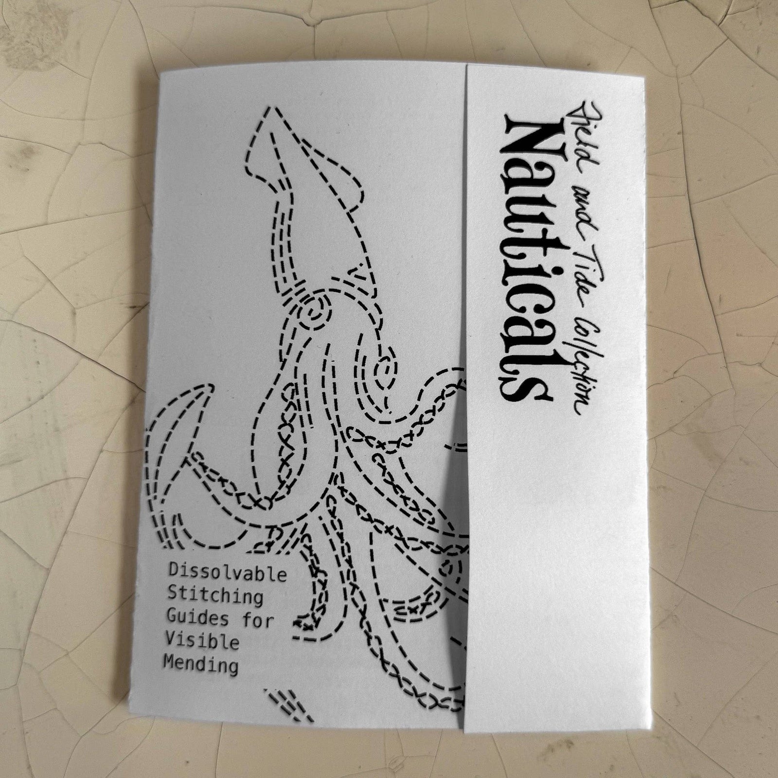 Booklet with nautical design and text on a textured surface