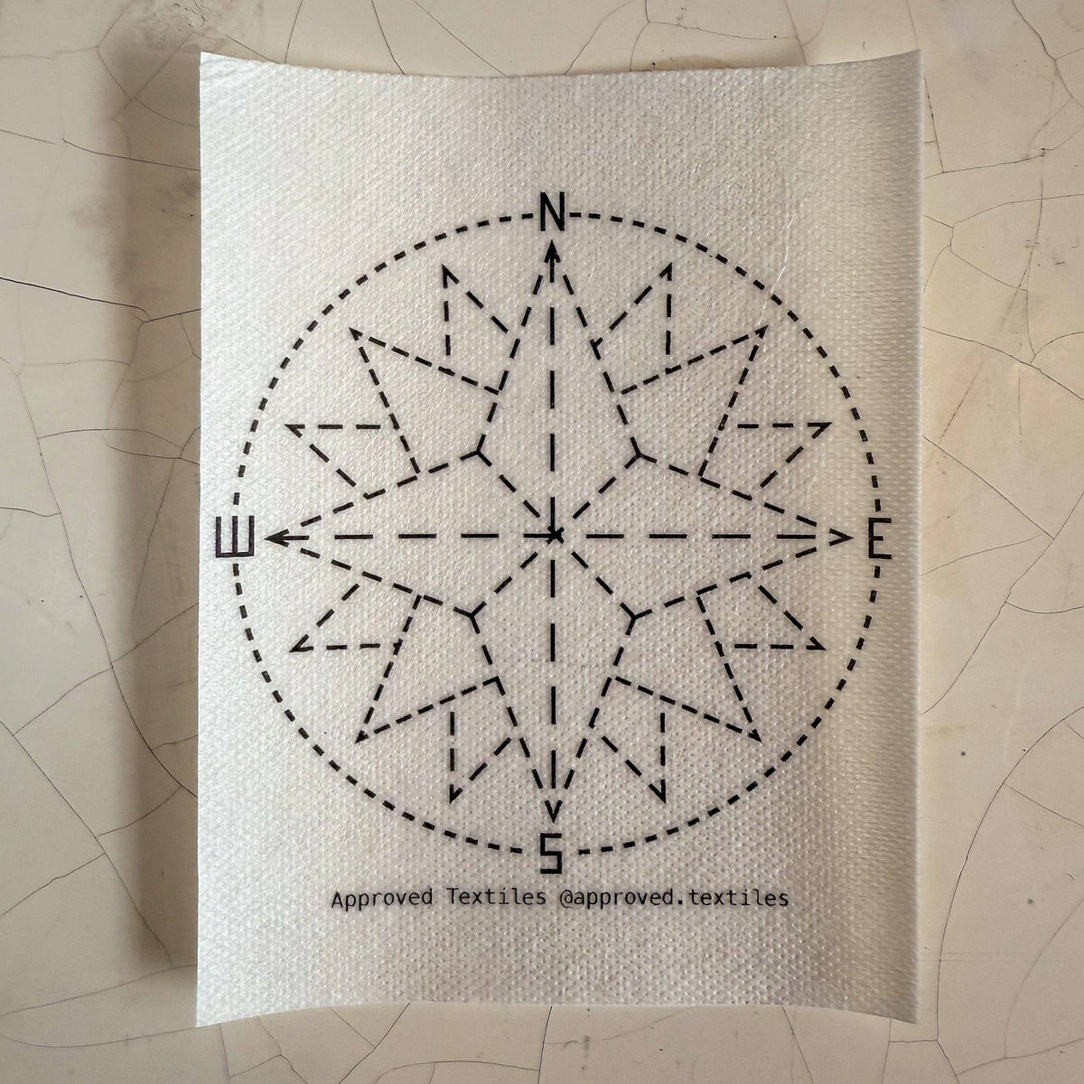 Visible mending pattern sticker featuring a compass rose. 