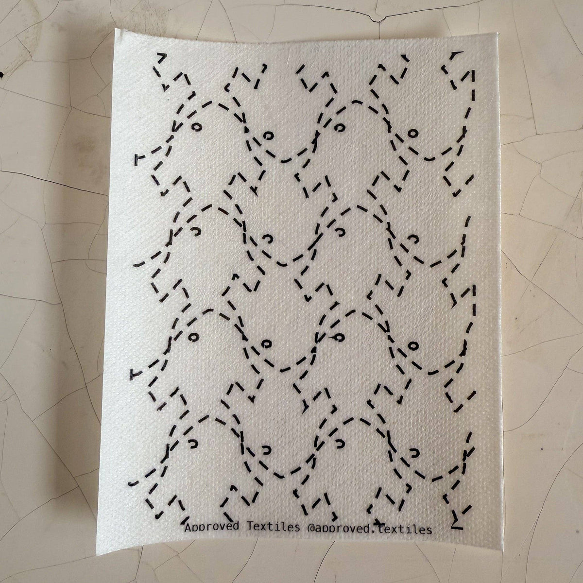 Visible mending pattern sticker featuring a tessellation of fish shapes with small eyeballs 