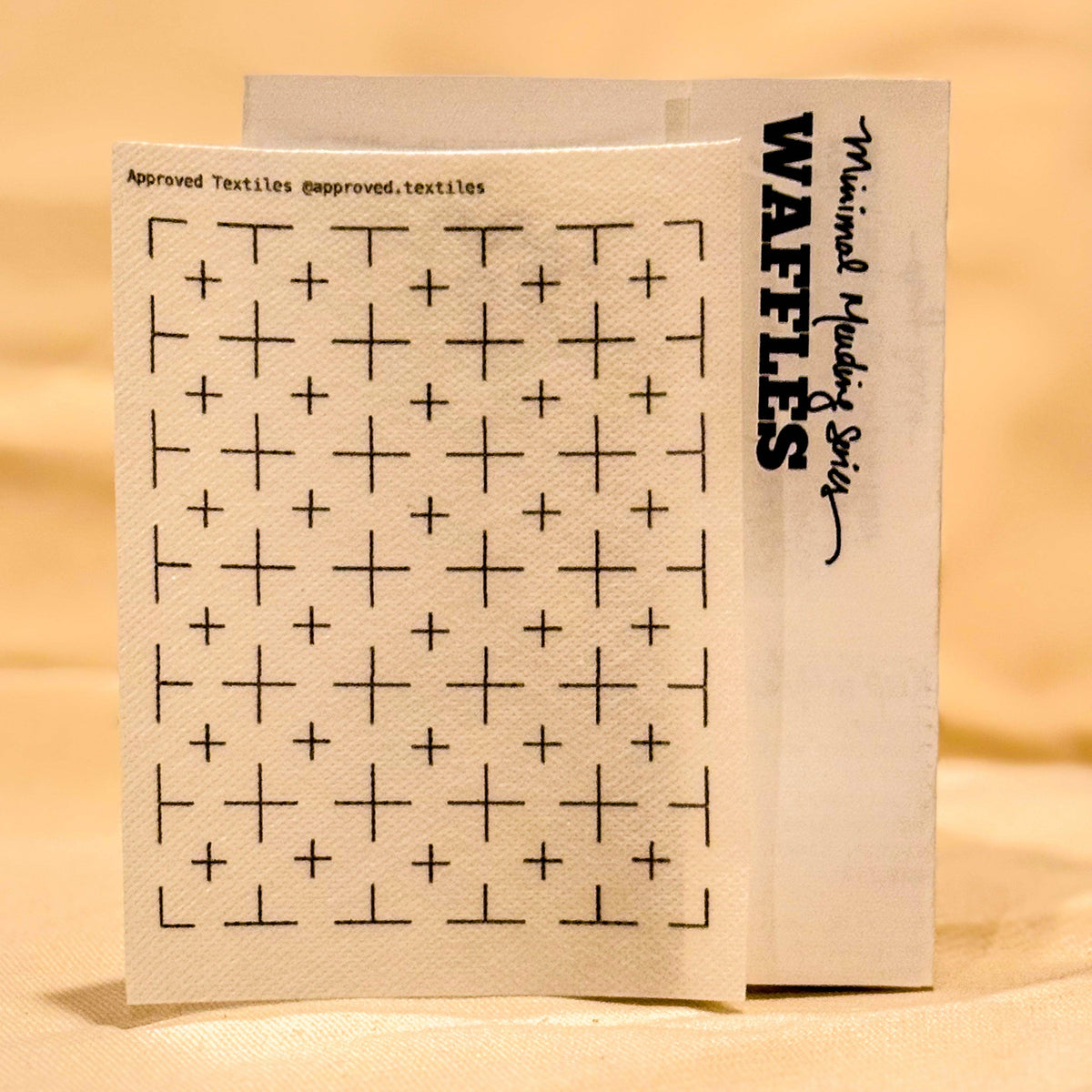 Visible mending pattern sticker featuring a grid with plus signs in each square