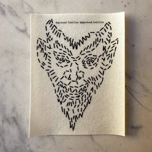Visible mending pattern sticker featuring a devilish face 