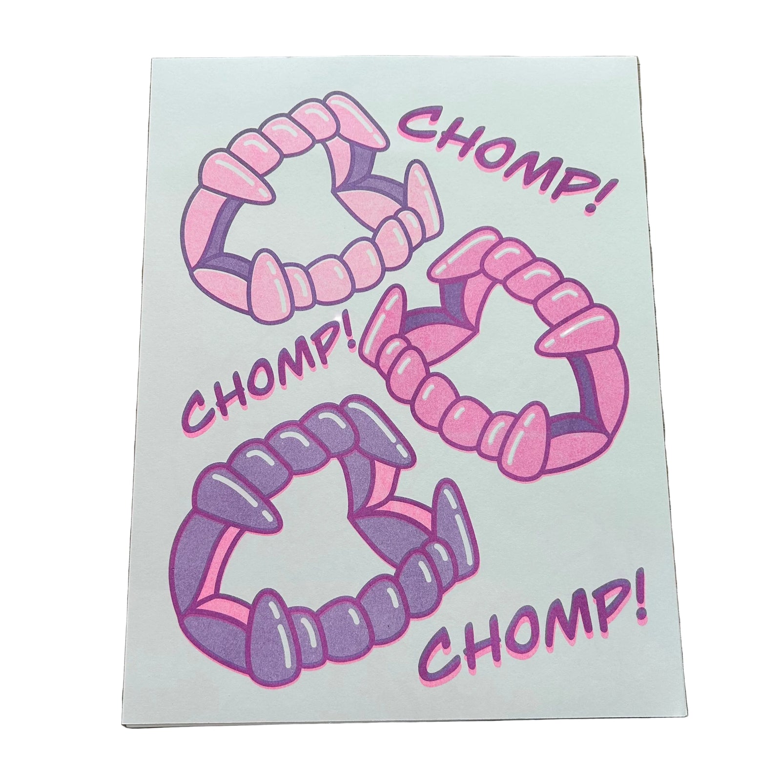 An art print of three Halloween-style vampire fangs and the words "chomp! chomp! chomp!"