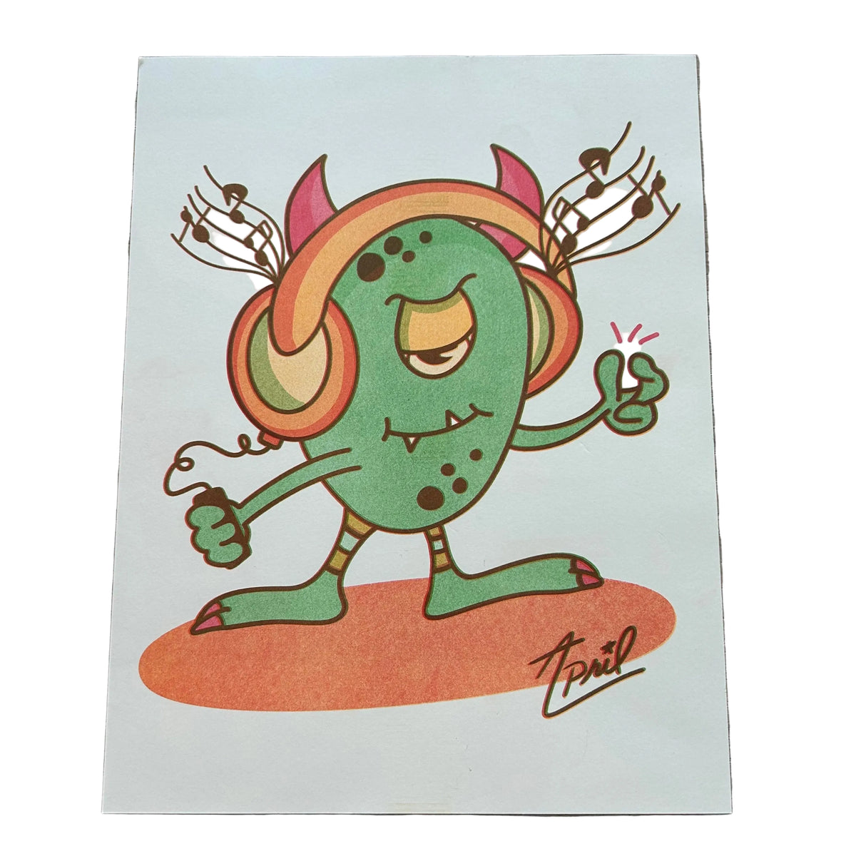 An art print of a green one-eyed monster wearing headphones and snapping to the music. 