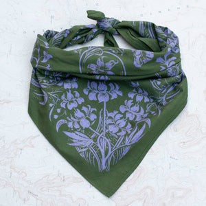 Green bandana with purple floral pattern on a textured white background