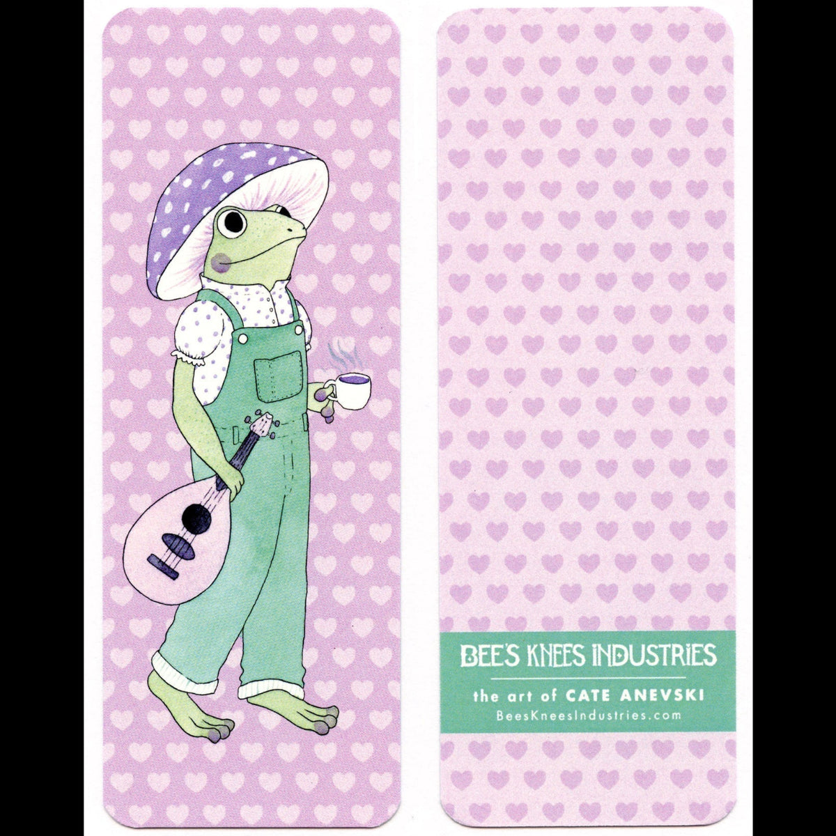 A bookmark with a frog wearing a mushroom hat and overalls and carrying a string instrument and a cup of coffee on one side and dark pink hearts on a light pink background on the other side.