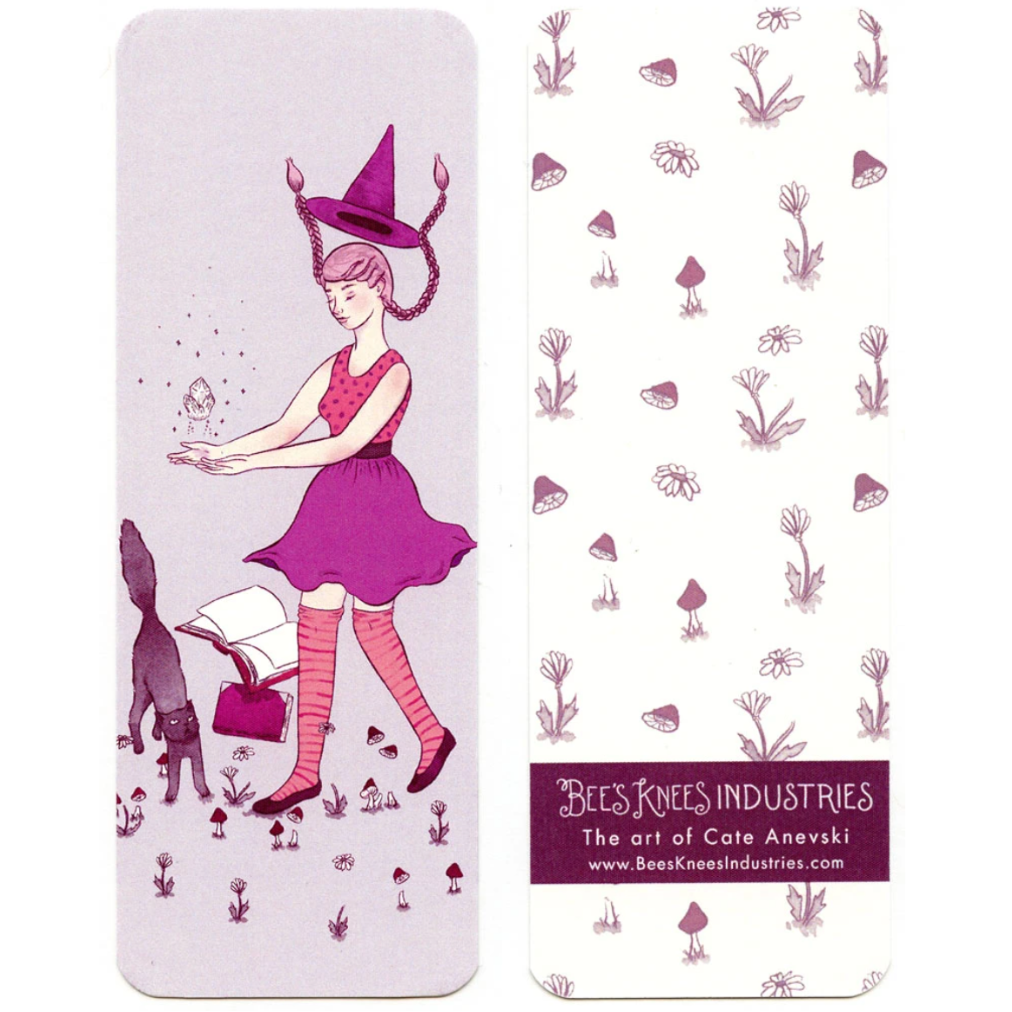 A bookmark that has a witch levitating a crystal on one side, and mushroom and flower illustrations against a white background on the other.