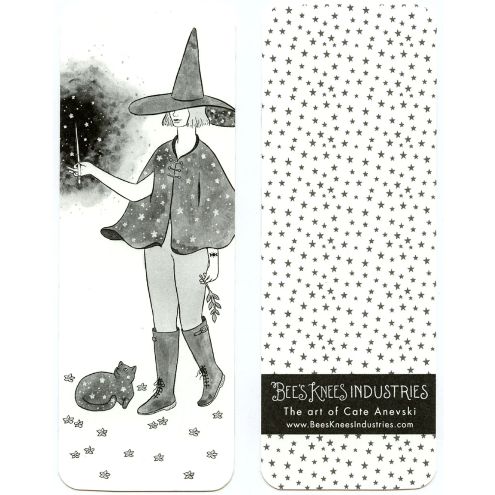 A bookmark with an illustration of a witch holding a wand with a cat on one side and a pattern of black stars on a white background on the other. 