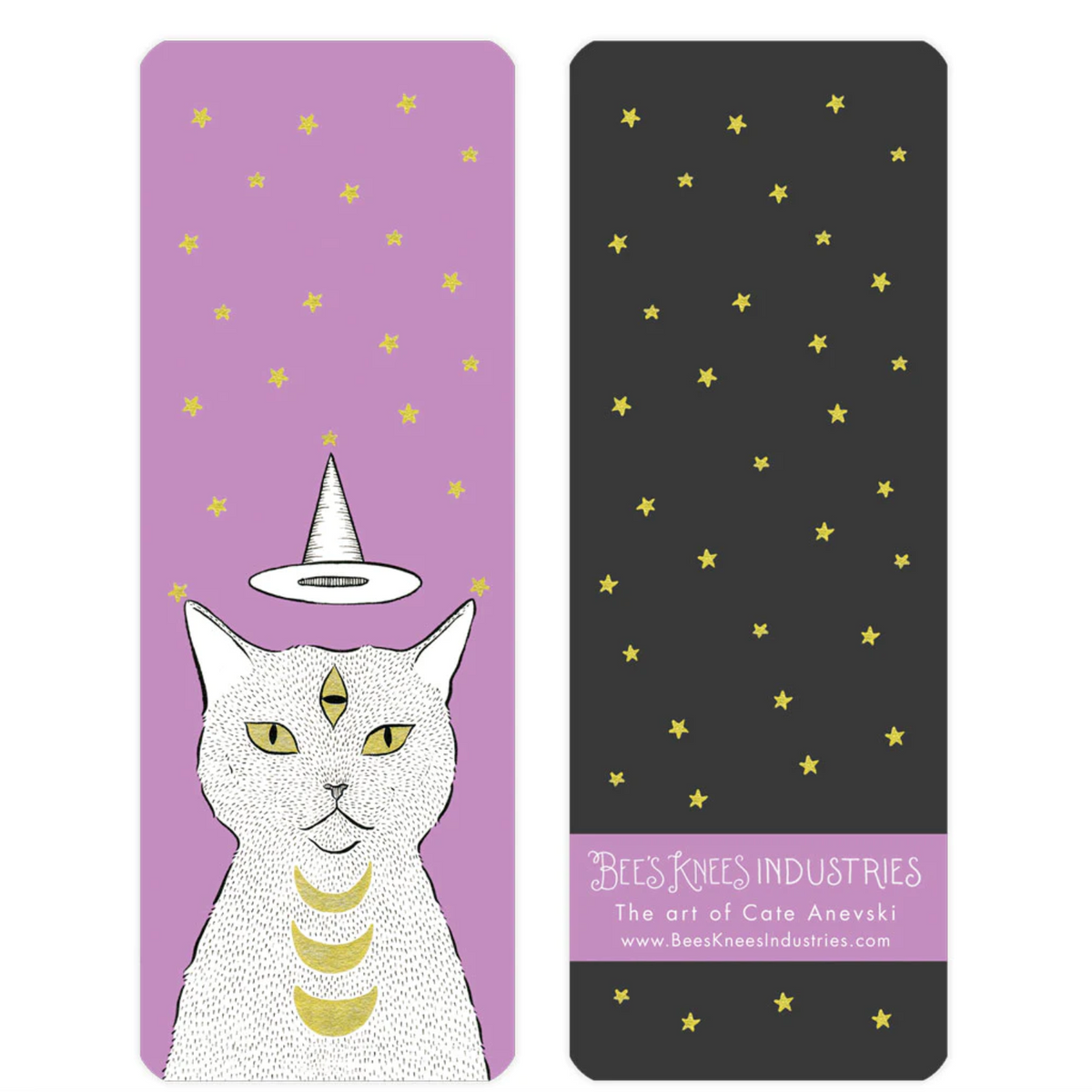 A bookmark that has a three-eyed cat with a witch hat floating above its head on one side, and gold stars against a black background on the other. 
