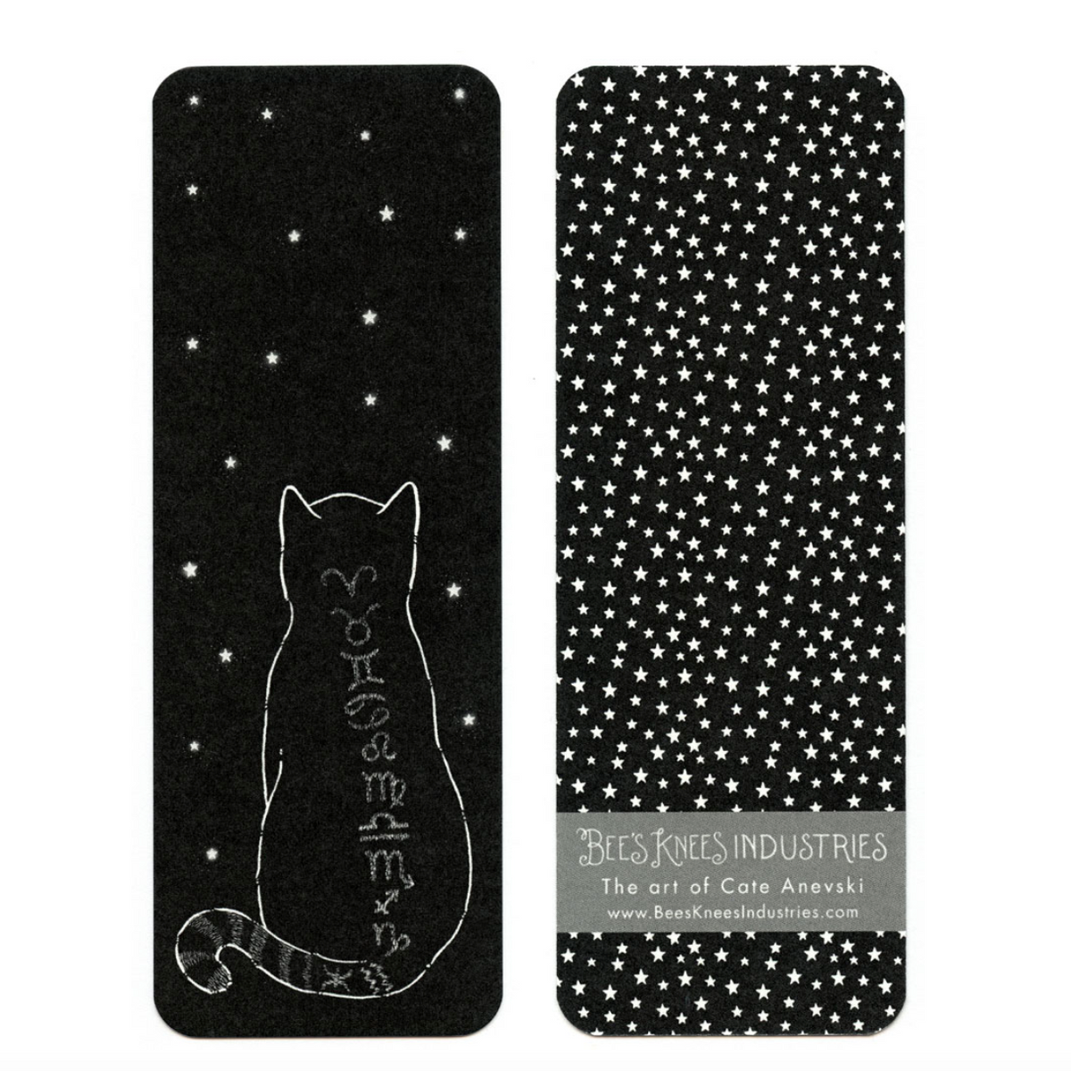 A bookmark with a black cat with zodiac signs on its back on one side and white stars on a black background on the other. 