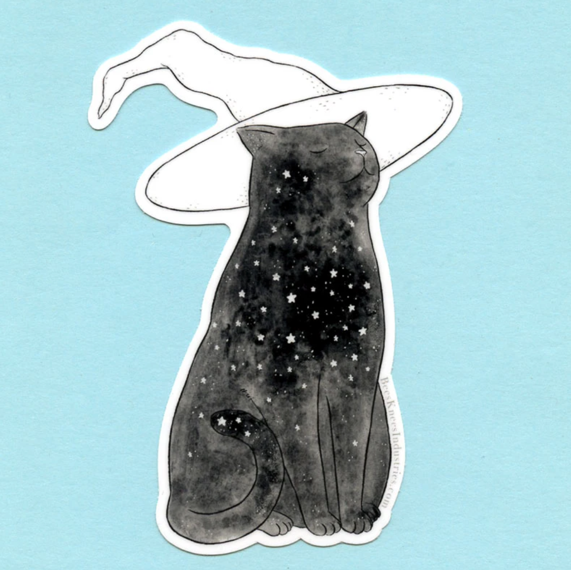 A sticker of a black cat with a star pattern on its body wearing a white witch hat against a blue background. 