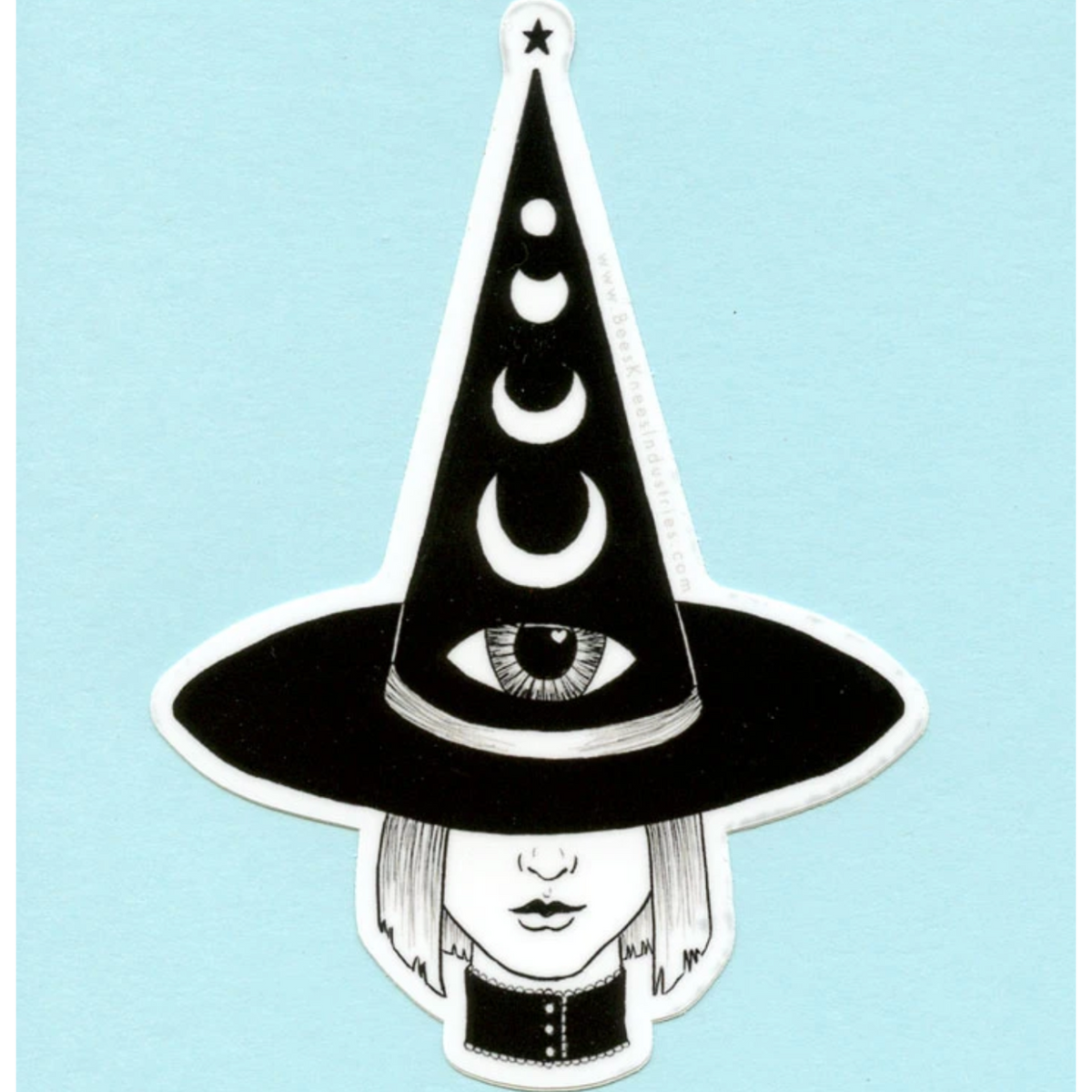 Black and white sticker of a witch with a bob haircut wearing a pointy hat that has an eye on it and different phases of the moon. 