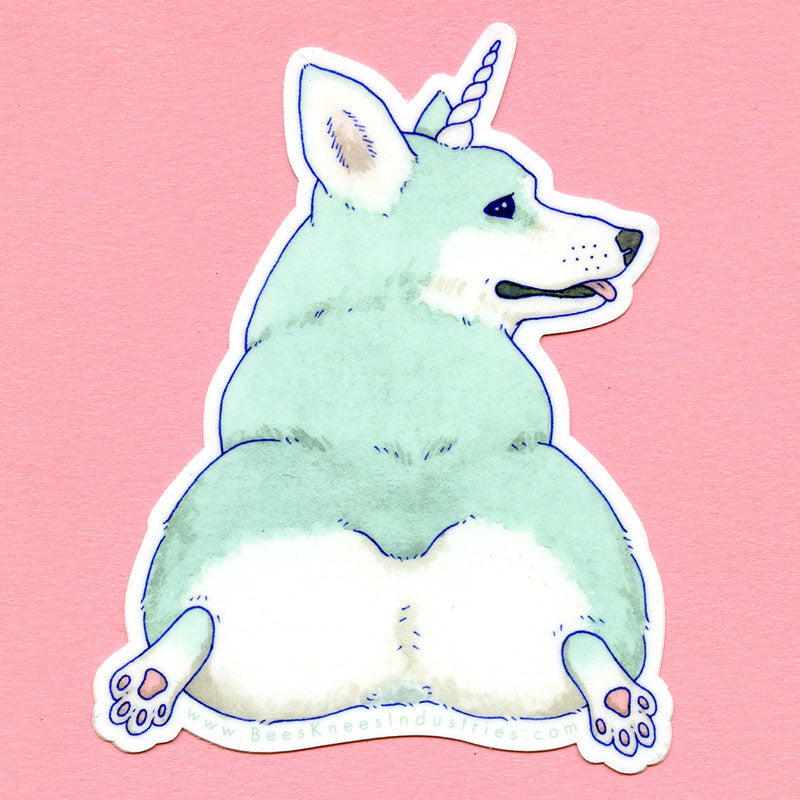 Sticker of a mint colored corgi with a unicorn horn against a pink background. 