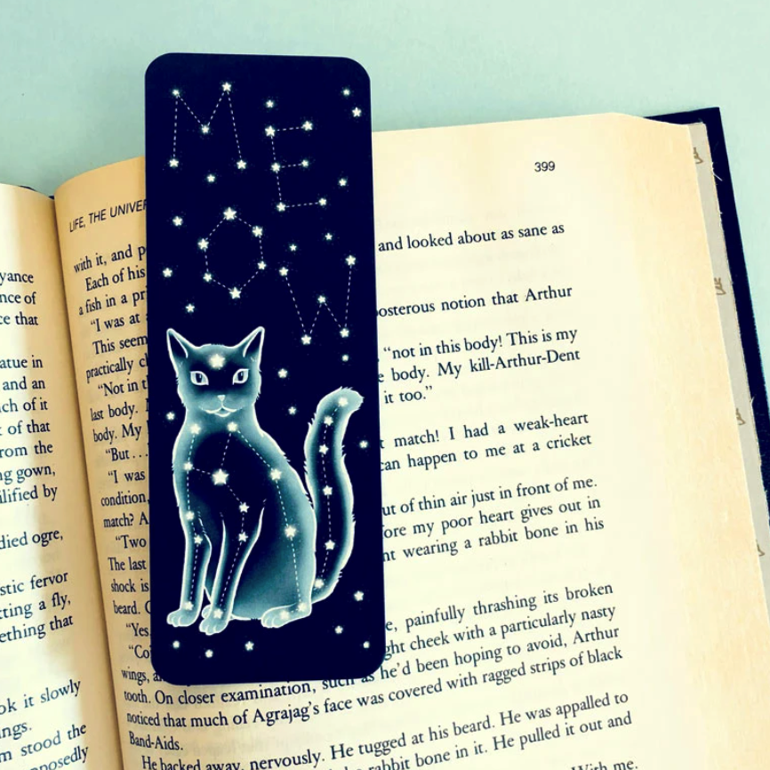 A dark blue bookmark with a cat and the word "meow" made of a constellation of stars 