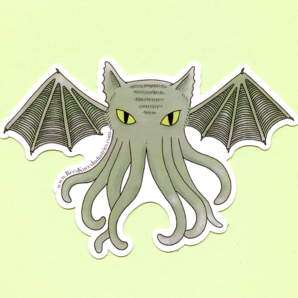A sticker of a creature with octopus legs, bat wings, and a cat head against a green background. 