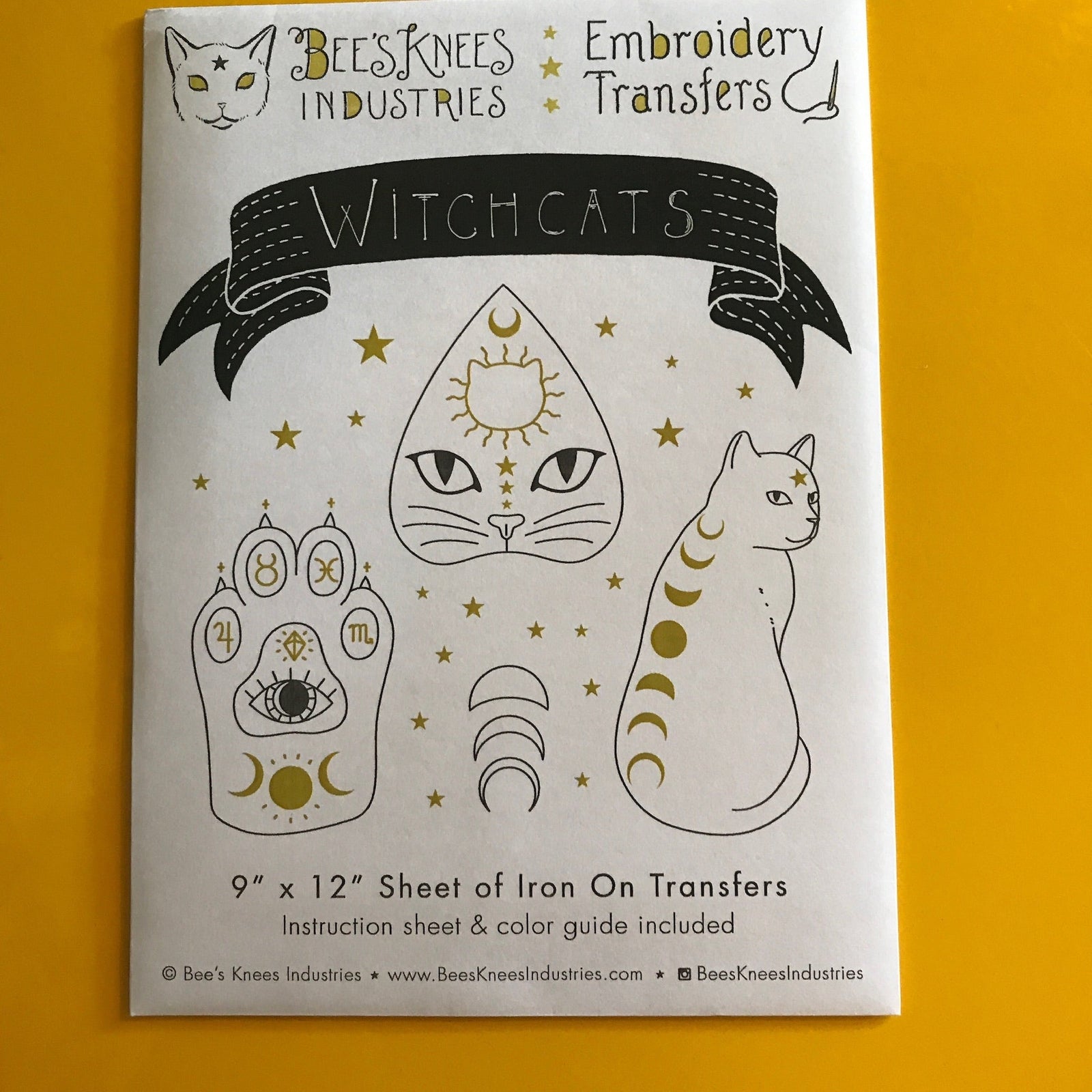 White envelope that says "Bee's Knees Industries Embroidery Transfers: Witchcats" and has illustrations of a cat's paw, a planchette, and a cat with moons on its back.