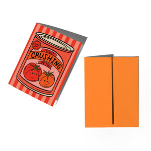 Card with a tomato sauce design and matching orange envelope on a white background