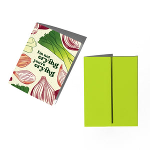 Greeting card with onion design and text 'I'm not crying, you're crying' on a white background