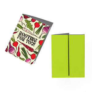 Greeting card with radish design and text 'Rooting for You!' next to a green envelope on a white background.