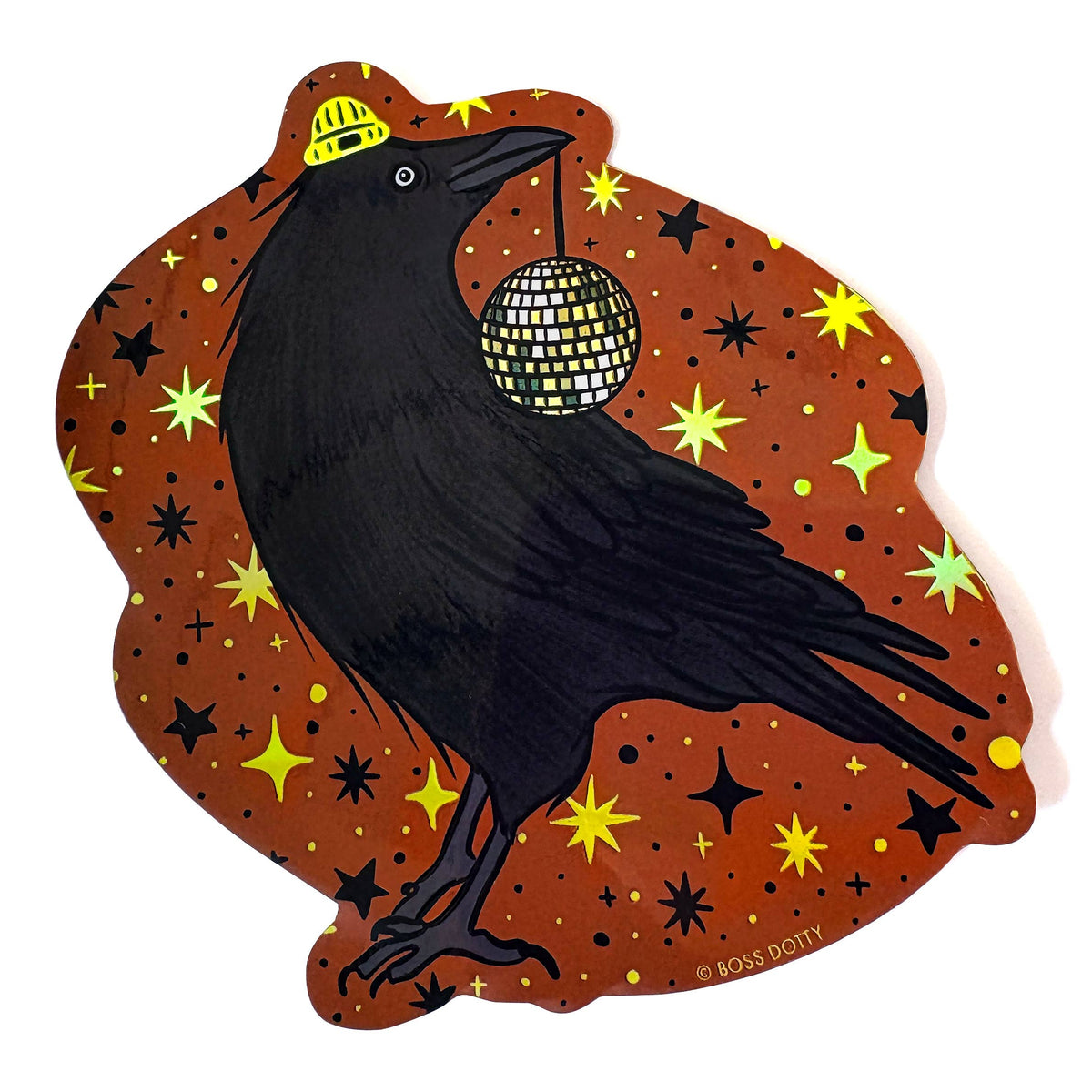 Black crow holding a disco ball on a brown background with stars