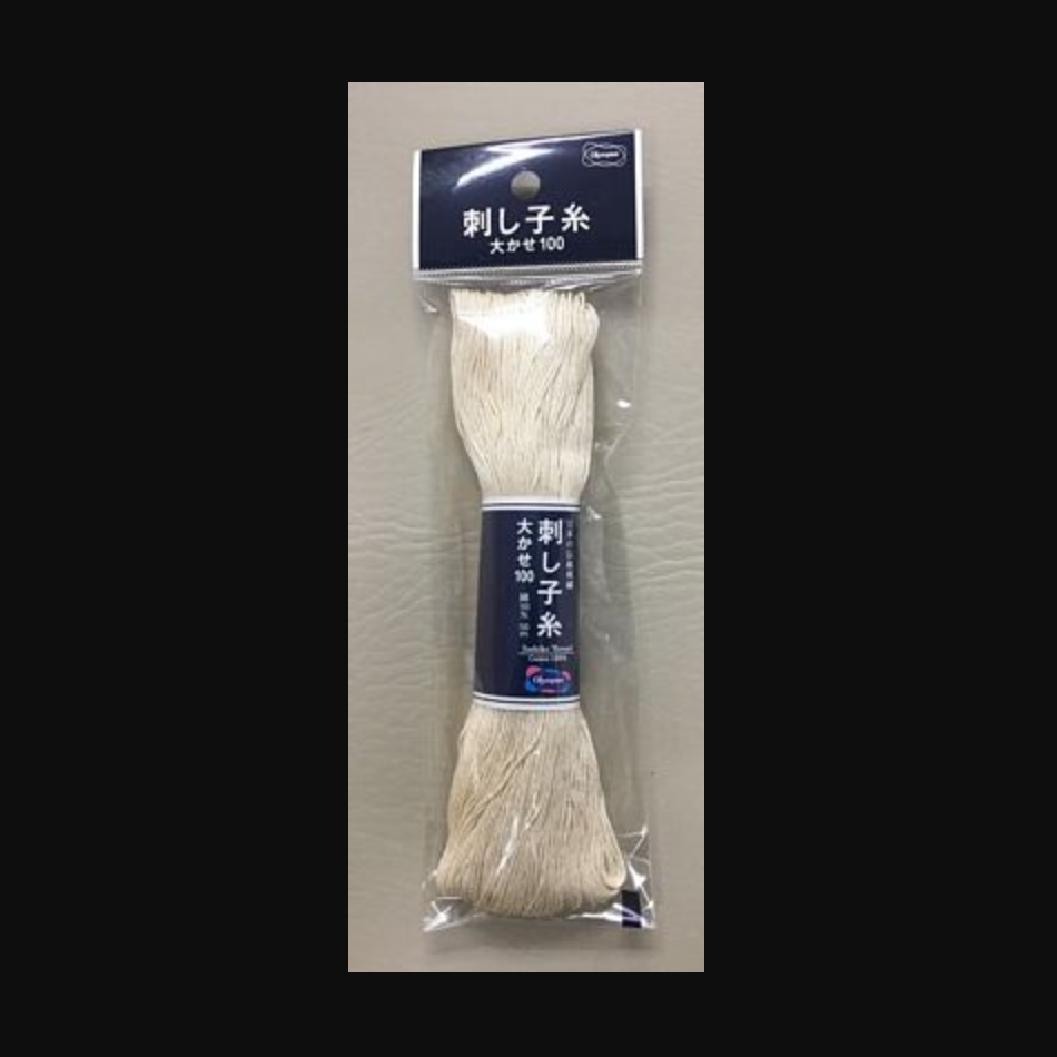White sashiko thread in plastic packaging with a blue label. 