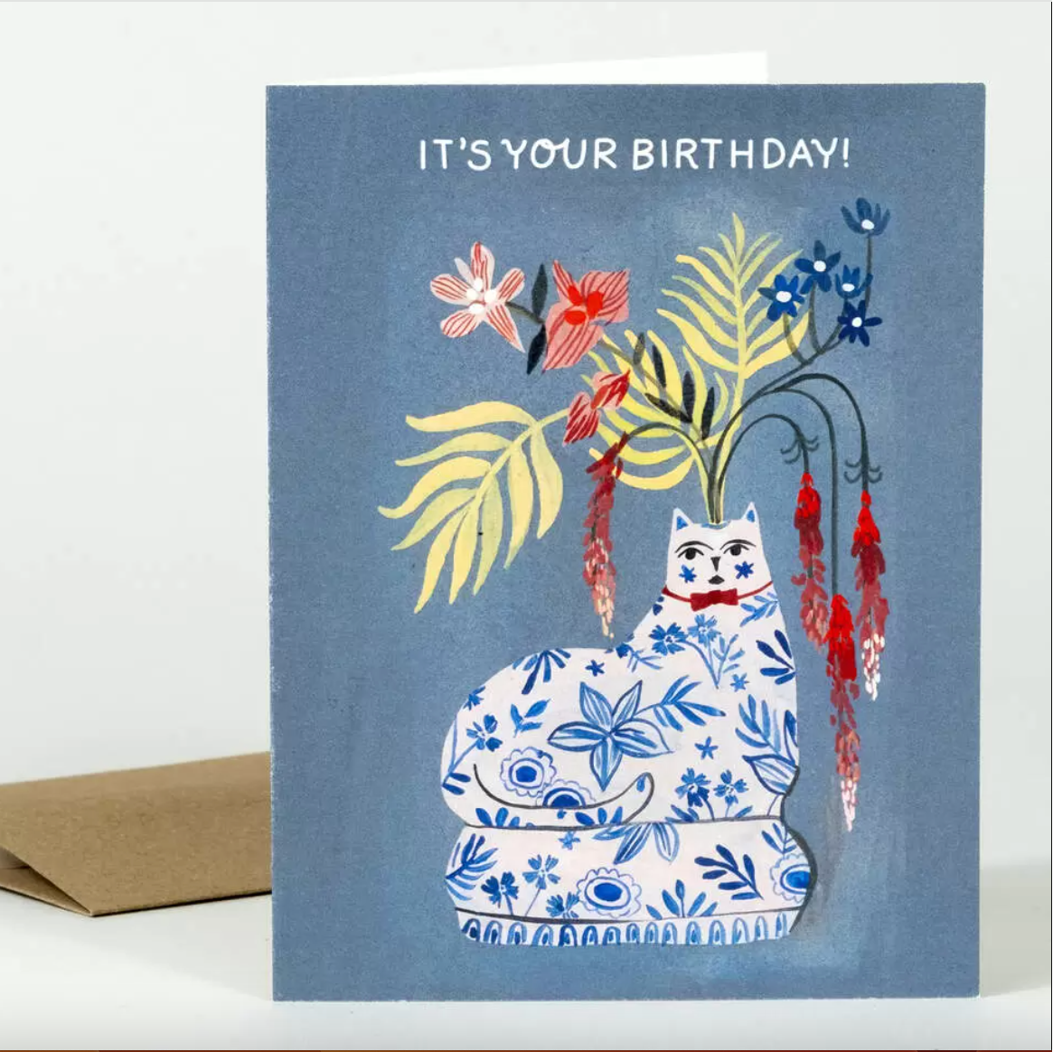 Birthday card with a decorative cat and floral design on a blue background