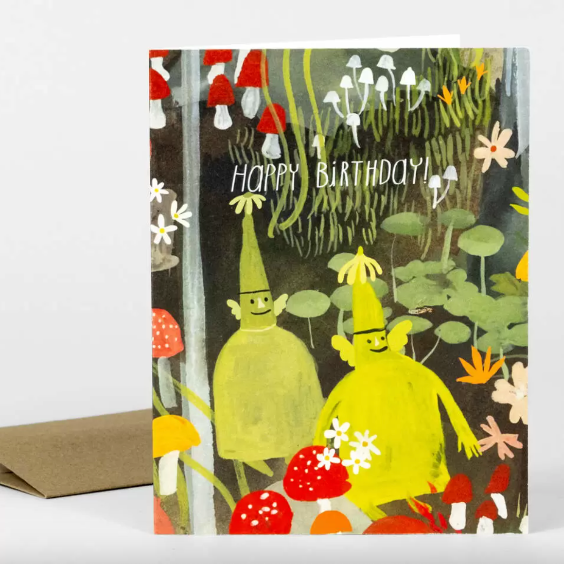 Birthday card with cartoon characters in a forest setting and 'Happy Birthday!' text.