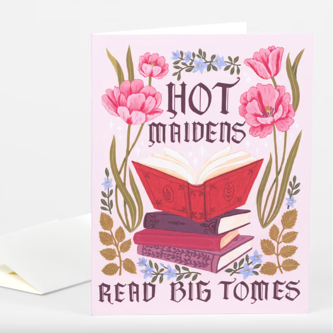 A pink card with a stack of books surrounded by flowers and text that reads "Hot Maidens Read Big Tomes"