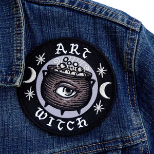 Patch with 'Art Witch' design on a denim jacket