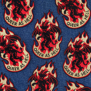 Pattern of devils with flames and 'Queer as Hell' text on a denim background