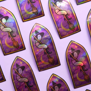 Holographic stickers of a worm witch on a broomstick on a purple background
