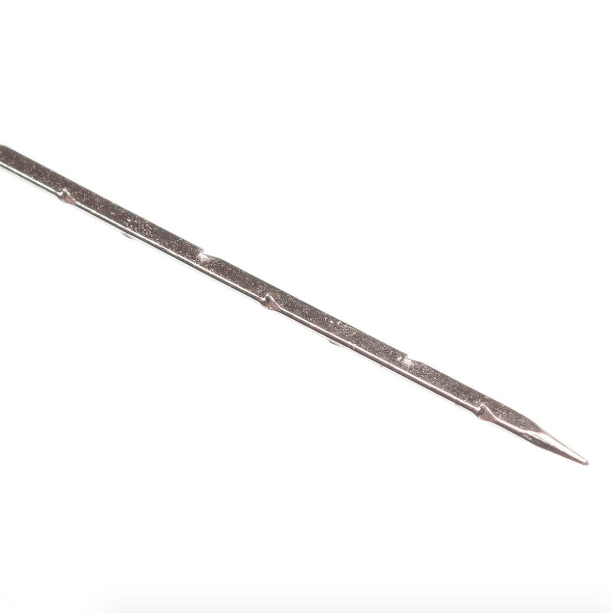 Close up of long, thin metal felting needle on a white background. 