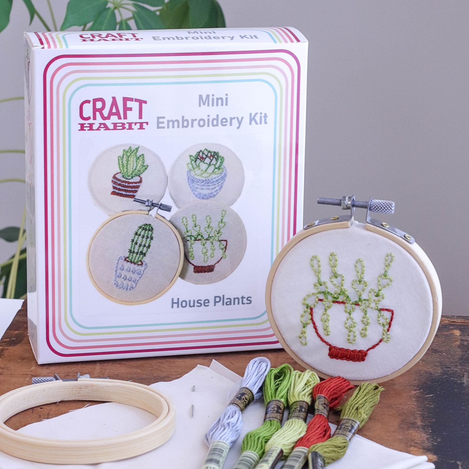 Craft Habit mini embroidery kit with house plants design, including a completed embroidery hoop and packaging.