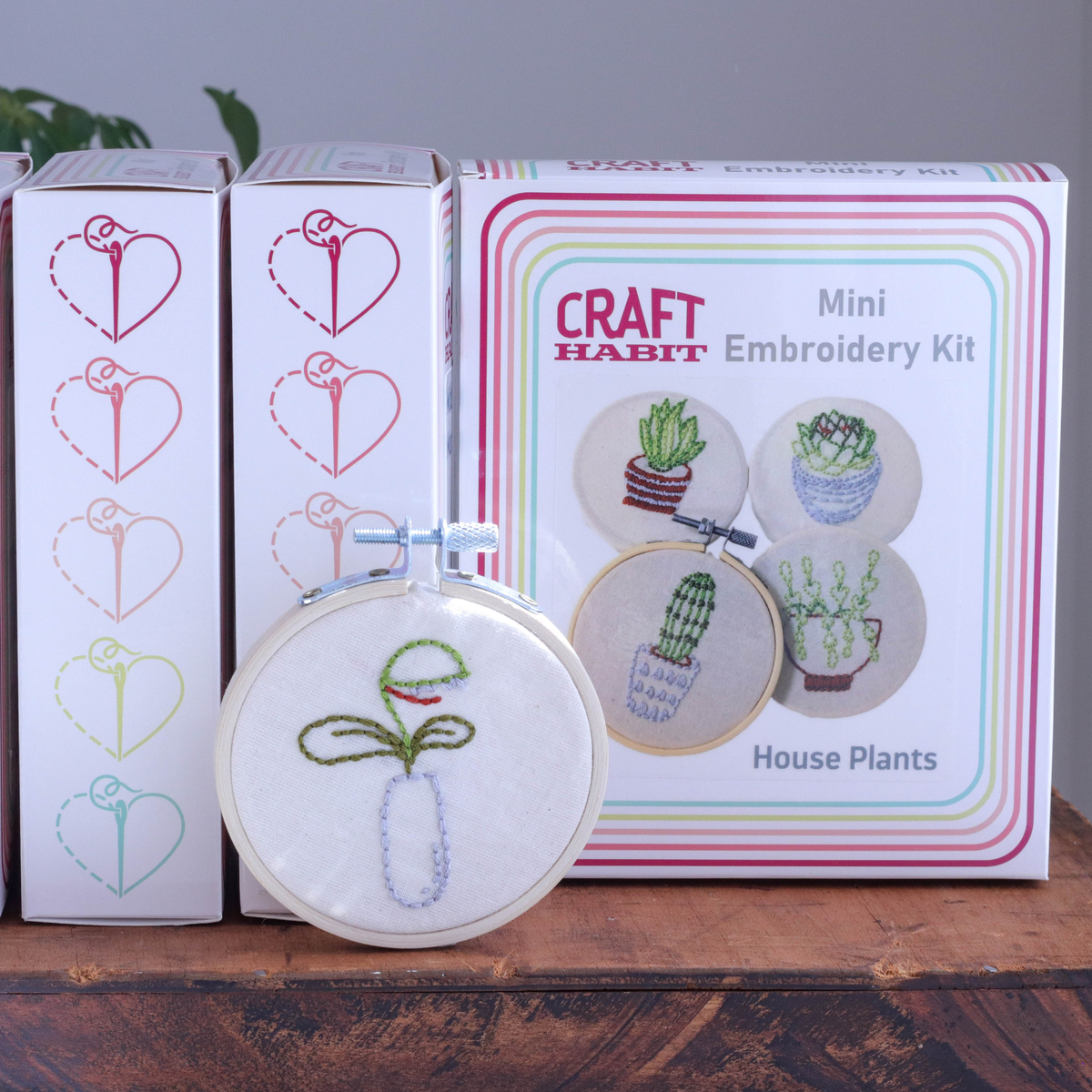 Craft Habit embroidery kit with a mini hoop featuring embroidered house plants on a wooden surface.