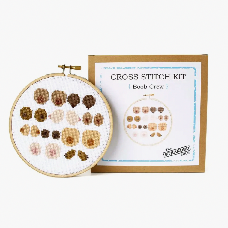 Cross stitch kit with embroidery hoop and 'Boob Crew' design on a white background
