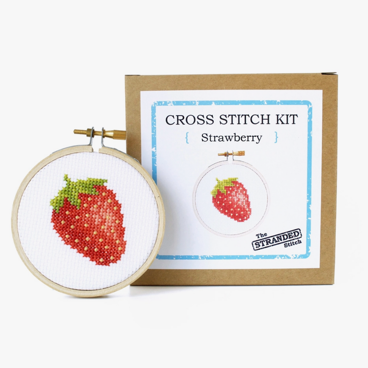 Cross stitch kit with strawberry design and box with 'The Stranded Stitch' branding on a white background