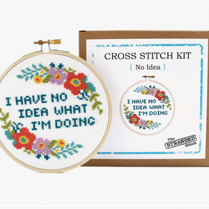 Cross stitch kit with hoop and completed design, featuring text 'I have no idea what I'm doing' and floral elements.