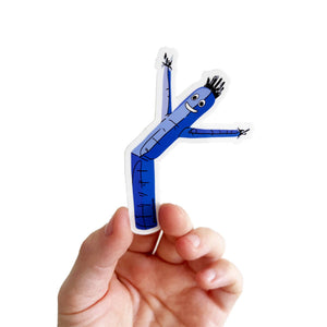 Sticker depicting a cartoon drawing of a blue air dancer. 