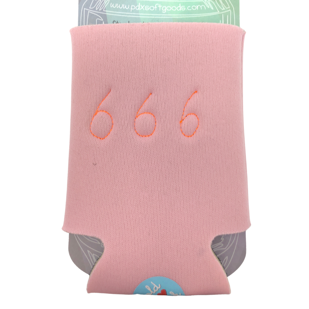 A light pink neoprene can cooler sleeve with orange embroidered numbers '666' on the front, holding a can of soda.