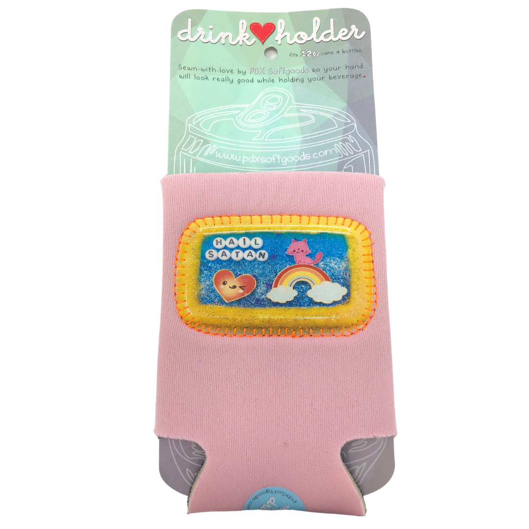 A pink neoprene drink holder koozie with a decorative 'HAIL SATAN' patch, shown on its original retail backing card against a white background.