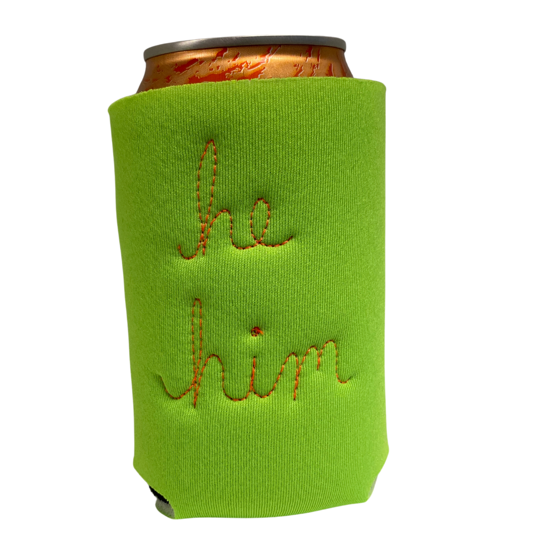 Light green neoprene drink holder with "he / him" embroidered on the back in cursive.