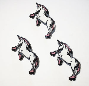 Three idential Ienamel pins of unicorns standing on their hind legs and wearing roller skates. 
