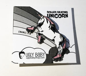 An enamel pin of a unicorn standing on hind legs and wearing roller skates. 
