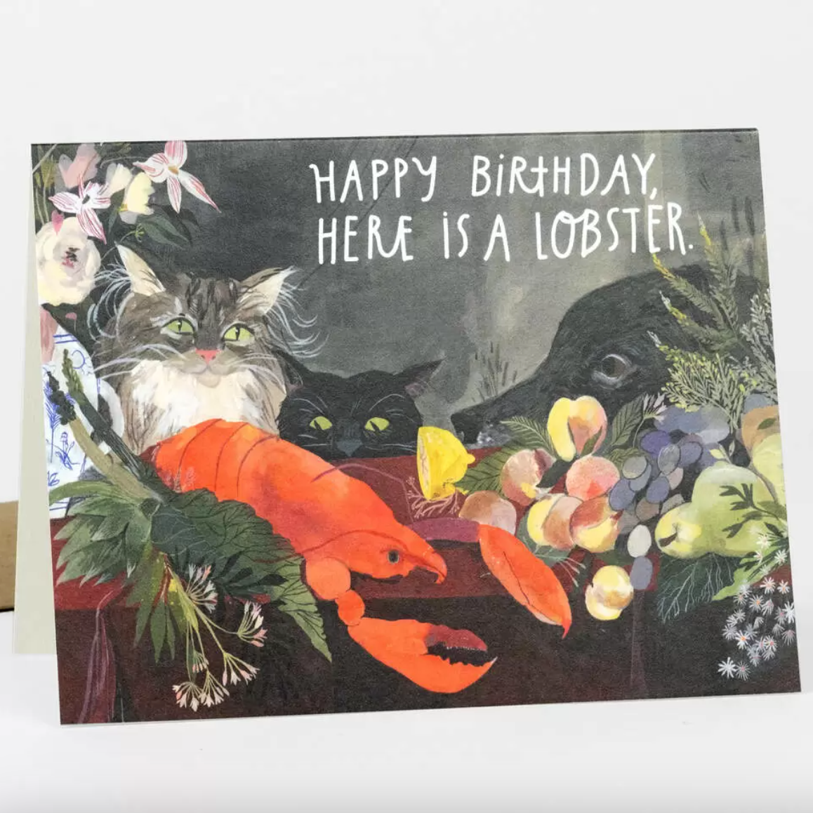Birthday card with cats and a lobster on a floral background with text that says "Happy birthday, here is a lobster."