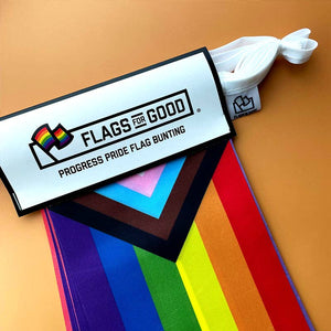 Packaging of 'Flags for Good' Progress Pride Flag Bunting on a brown background