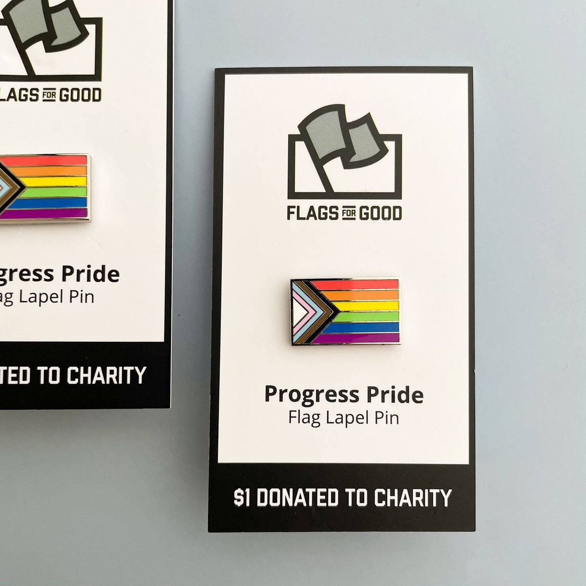 Progress Pride flag lapel pin with 'Flags for Good' branding on a white background